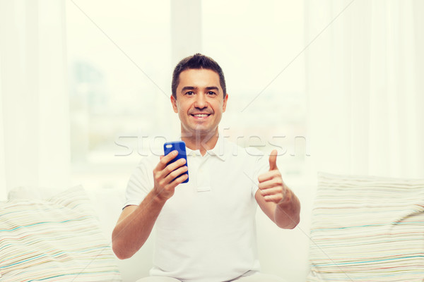 Heureux homme smartphone maison technologie personnes [[stock_photo]] © dolgachov