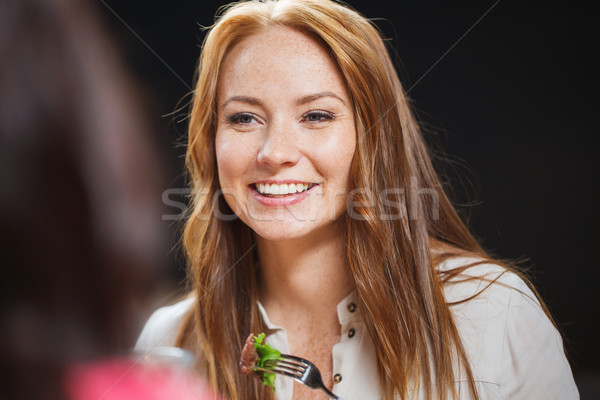 happy young woman having dinner at restaurant Stock photo © dolgachov