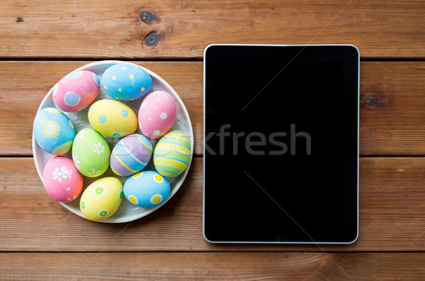 close up of easter eggs and blank tablet pc Stock photo © dolgachov