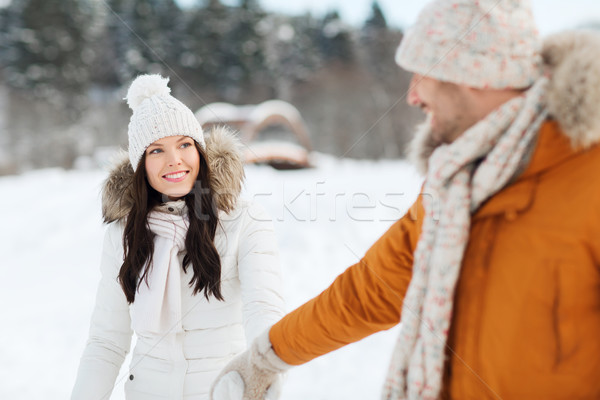 happy couple walking along snowy winter field Stock photo © dolgachov