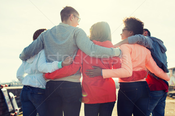 group of happy teenage friends hugging on street Stock photo © dolgachov