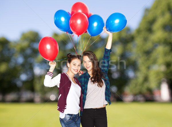 happy teenage girls with helium balloons Stock photo © dolgachov