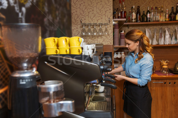 barista woman making coffee by machine at cafe Stock photo © dolgachov