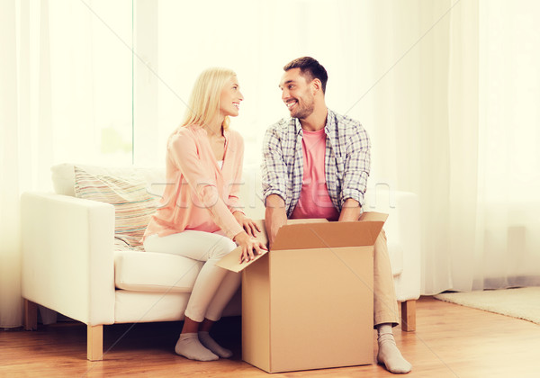 happy couple with cardboard box or parcel at home Stock photo © dolgachov