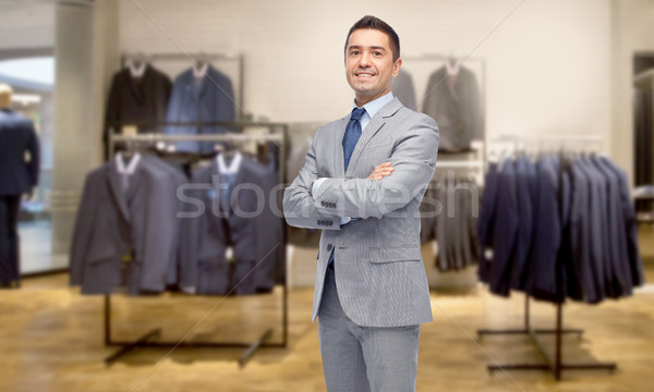 happy businessman in suit over clothing store Stock photo © dolgachov