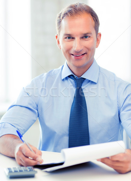 бизнесмен ноутбук калькулятор фотография красивый человека Сток-фото © dolgachov