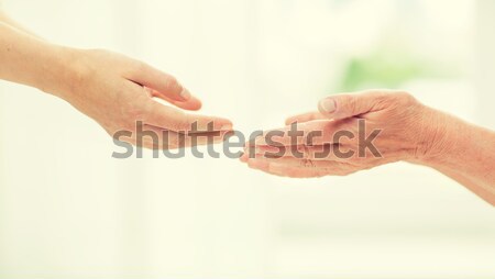 close up of senior and young woman hands Stock photo © dolgachov