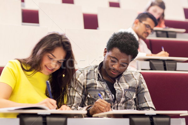 group of students with notebooks in lecture hall Stock photo © dolgachov