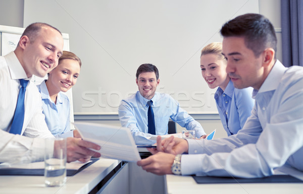 group of smiling businesspeople meeting in office Stock photo © dolgachov