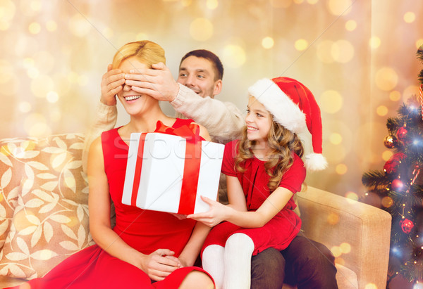 father and daughter surprise mother with gift box Stock photo © dolgachov