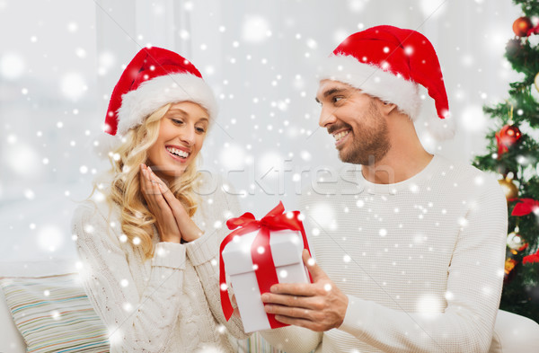 happy couple at home with christmas gift box Stock photo © dolgachov