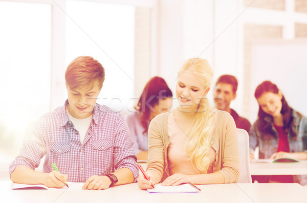 two teenagers with notebooks at school Stock photo © dolgachov