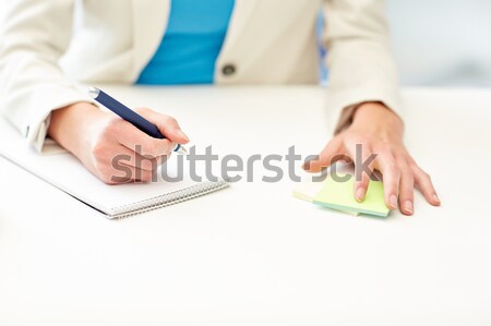 close up of woman with to notepad at office Stock photo © dolgachov