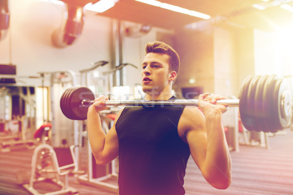 молодым человеком мышцы штанга спортзал спорт Сток-фото © dolgachov