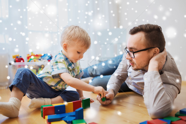 Stock photo: father and son playing with toy blocks at home