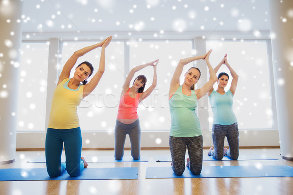 happy pregnant women exercising on mats in gym Stock photo © dolgachov