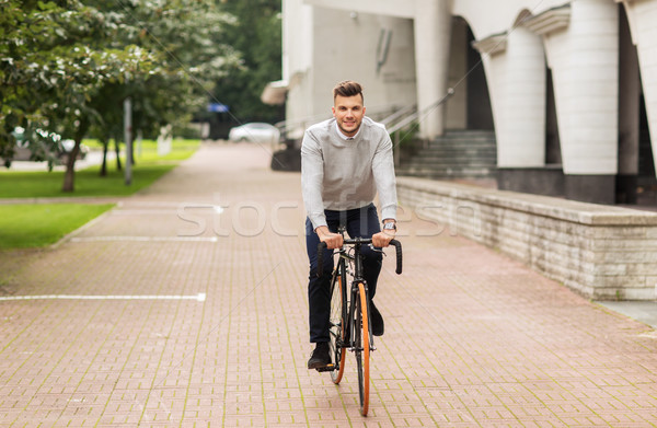 Stock photo: young man riding bicycle on city street