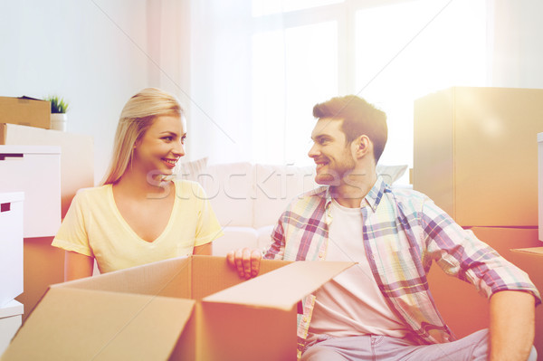 smiling couple with many boxes moving to new home Stock photo © dolgachov