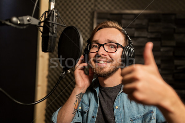 man with headphones at music recording studio Stock photo © dolgachov