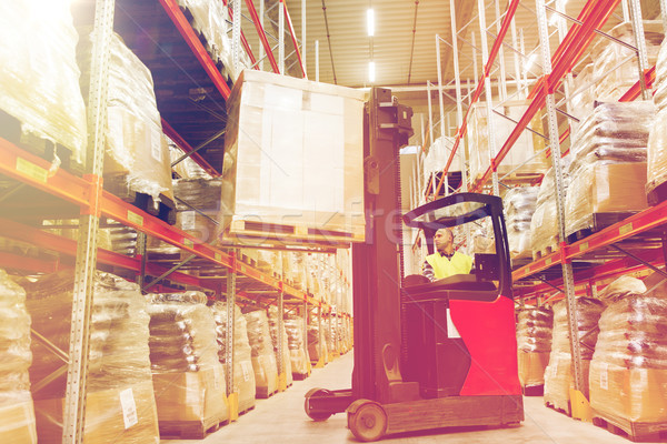 man on forklift loading cargo at warehouse Stock photo © dolgachov