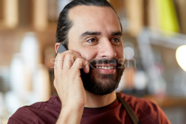 close up of man or waiter calling on smartphone Stock photo © dolgachov