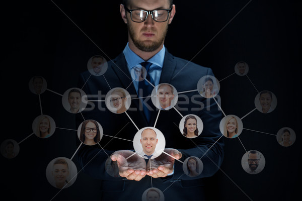 businessman with network contacts over black Stock photo © dolgachov