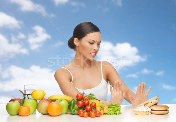 woman with fruits rejecting fast food Stock photo © dolgachov