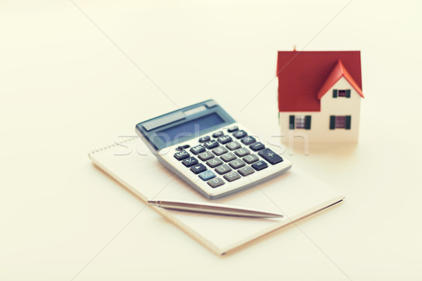 close up of home model, calculator and notebook Stock photo © dolgachov