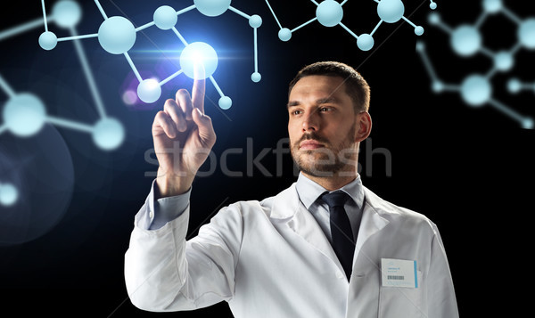 doctor or scientist in white coat with molecules Stock photo © dolgachov