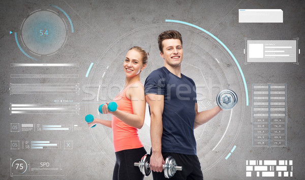 sportive man and woman with dumbbells Stock photo © dolgachov