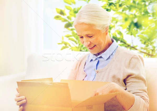 happy senior woman with parcel box at home Stock photo © dolgachov