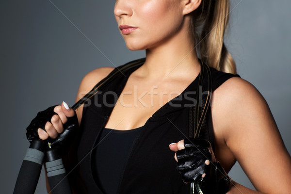 Stock photo: close up of sporty woman with jumping rope