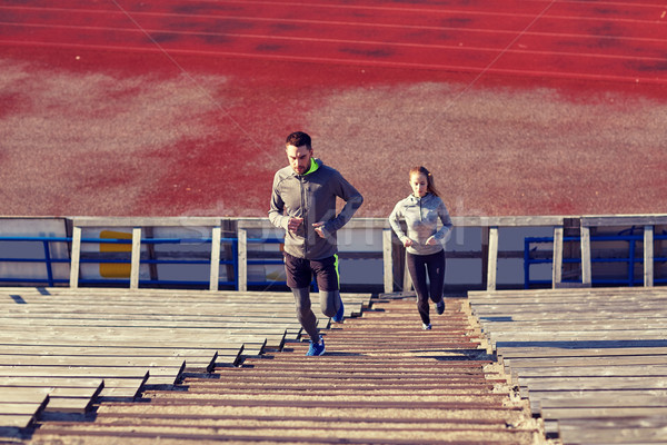 couple running upstairs on stadium Stock photo © dolgachov