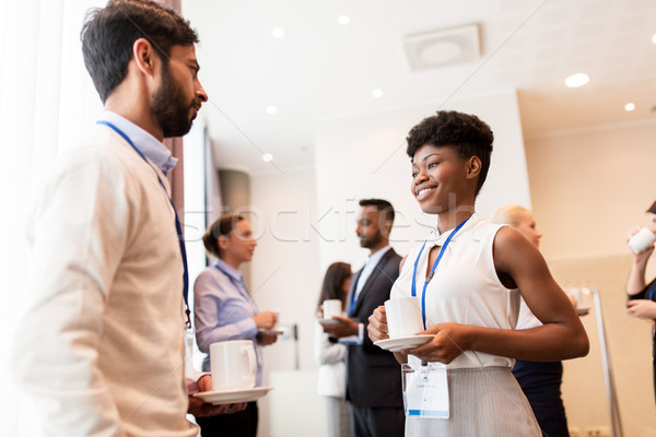 business people with conference badges and coffee Stock photo © dolgachov