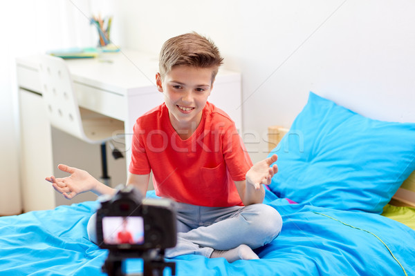 happy boy with camera recording video at home Stock photo © dolgachov