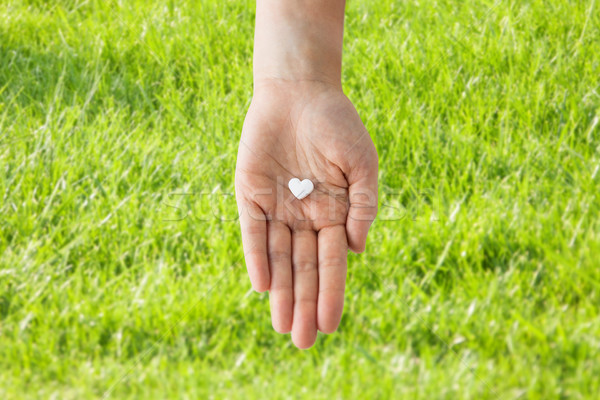 close up of hand holding medicine heart pill Stock photo © dolgachov