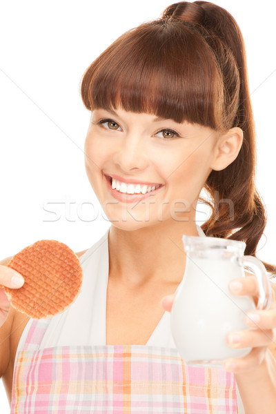Stock photo: housewife with milk and cookies