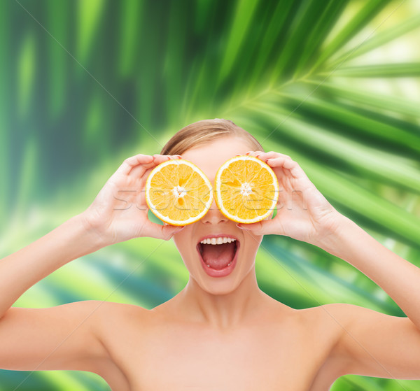 amazed young woman with orange slices Stock photo © dolgachov