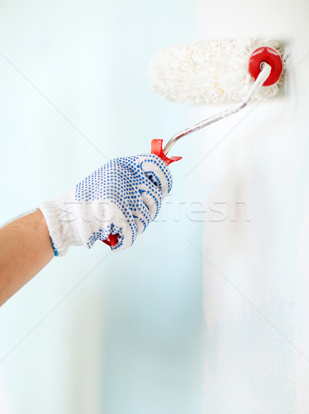 close up of male in gloves painting wall Stock photo © dolgachov