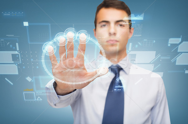 attractive buisnessman working with virtual sceen Stock photo © dolgachov