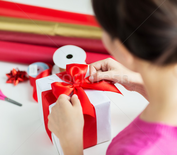 Stock photo: close up of woman decorating christmas presents