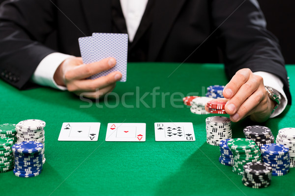 poker player with cards and chips at casino Stock photo © dolgachov