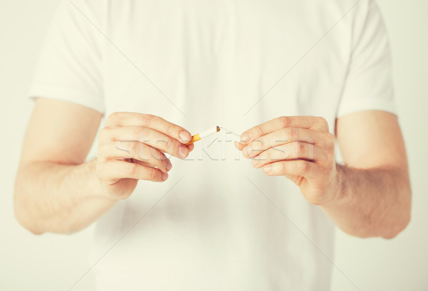 man breaking the cigarette with hands Stock photo © dolgachov