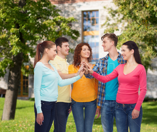 group of smiling teenagers over campus background Stock photo © dolgachov