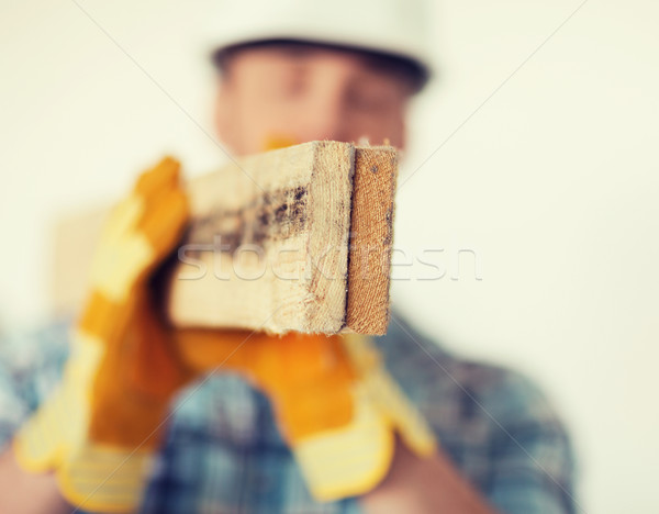 close up of male in gloves carrying wooden boards Stock photo © dolgachov