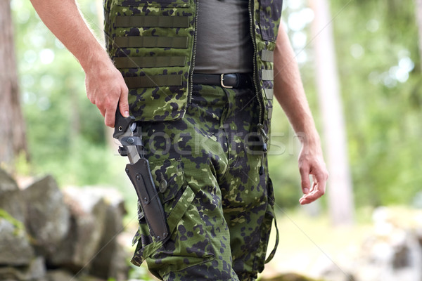 close up of soldier or hunter with knife in forest Stock photo © dolgachov