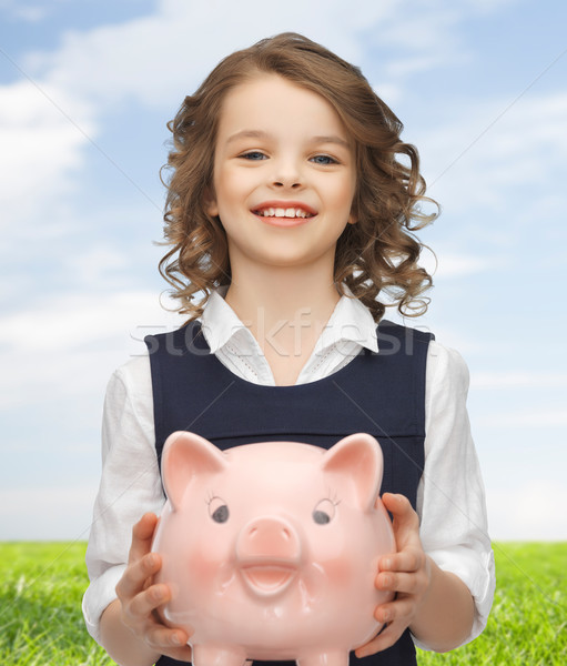 happy girl holding piggy bank Stock photo © dolgachov