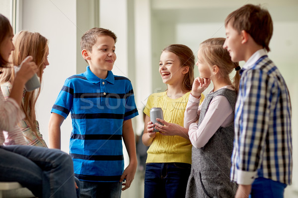 group of school kids with soda cans in corridor Stock photo © dolgachov