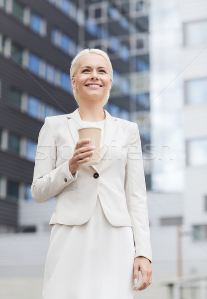 smiling businesswoman with paper cup outdoors Stock photo © dolgachov