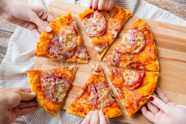 close up of hands and homemade pizza Stock photo © dolgachov